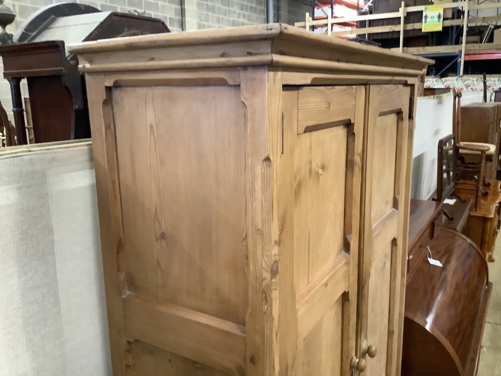 A Victorian panelled pitched pine two door cabinet, width 108cm depth 40cm height 198cm